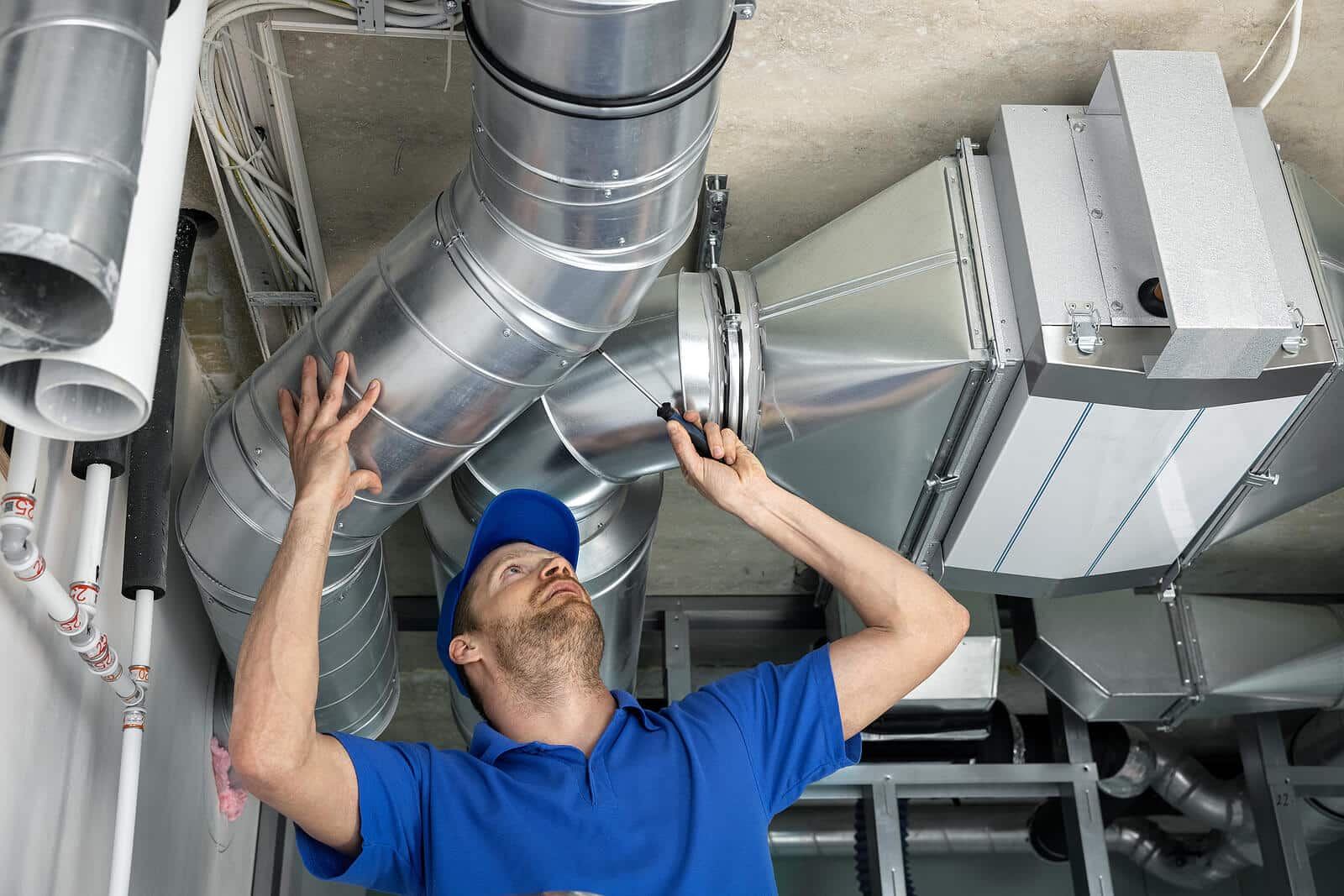 HVAC technician inspecting and repairing air ducts in Newark