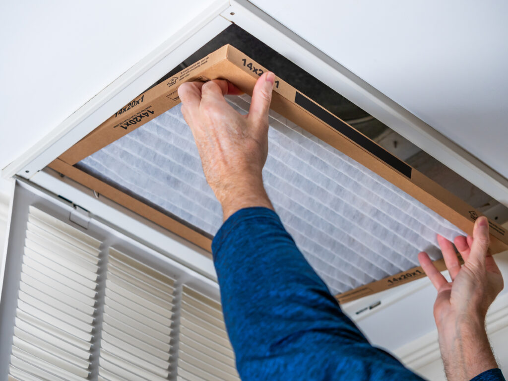 HVAC technician replacing a home air filter in Newark