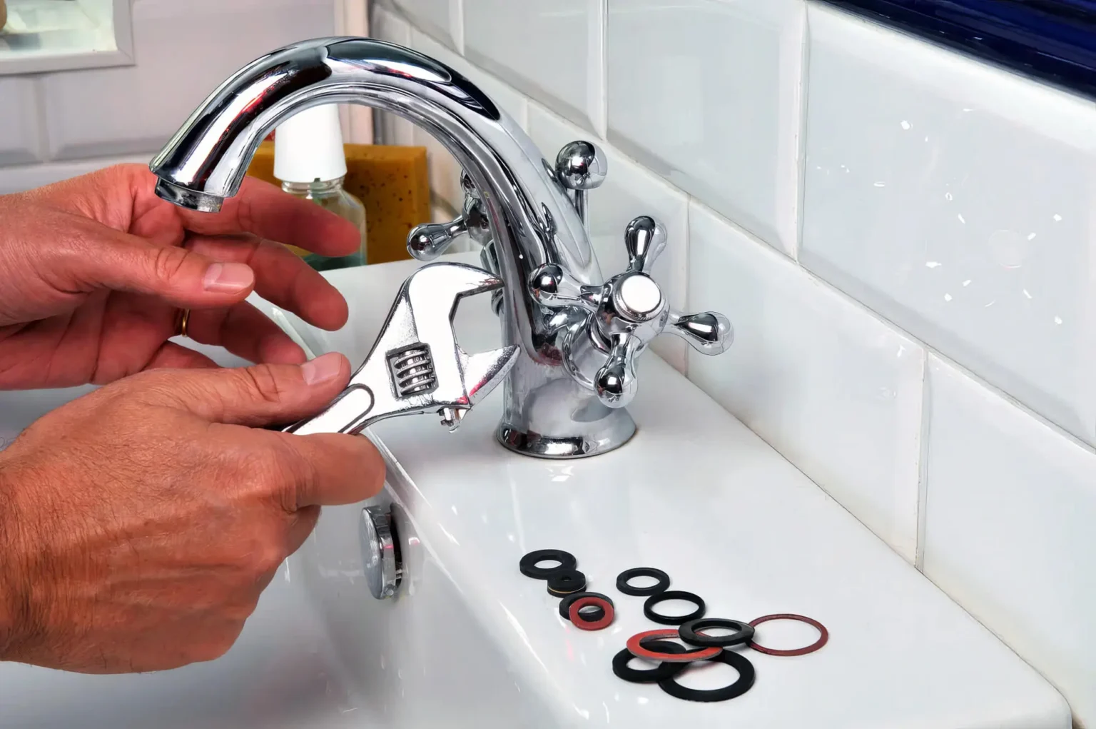 Plumber maintaining a bathroom faucet in Newark
