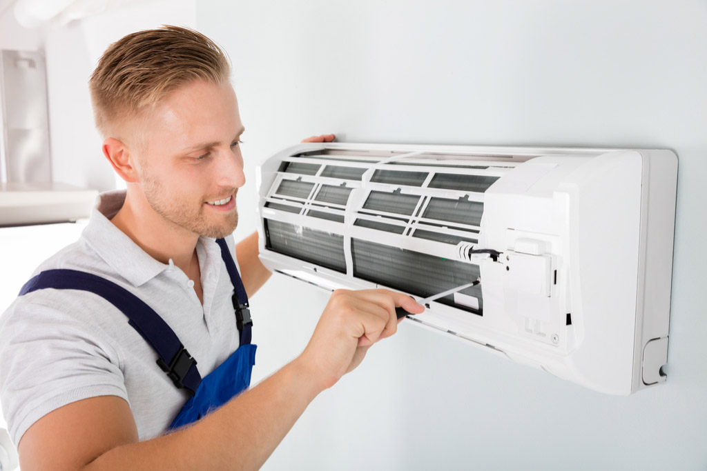 HVAC technician maintaining a ductless air conditioner in Newark