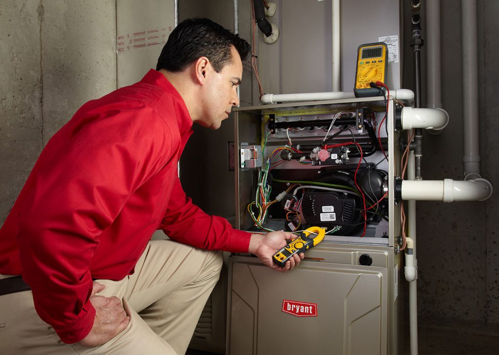Heating technician diagnosing a furnace repair in Newark