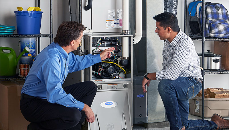Technician evaluating a furnace for repair or replacement in Newark