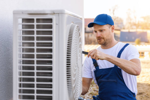 HVAC technician servicing an outdoor air conditioner in Newark