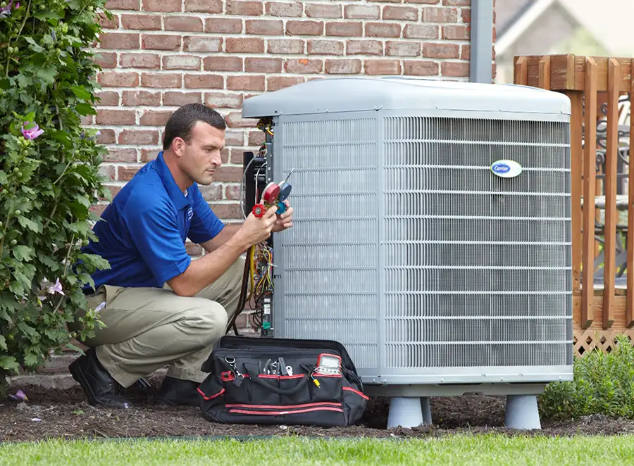 HVAC technician inspecting an outdoor AC unit in Newark