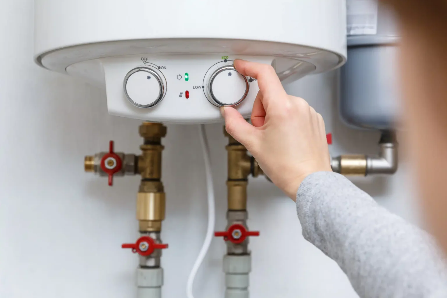 Technician adjusting a water heater in Newark